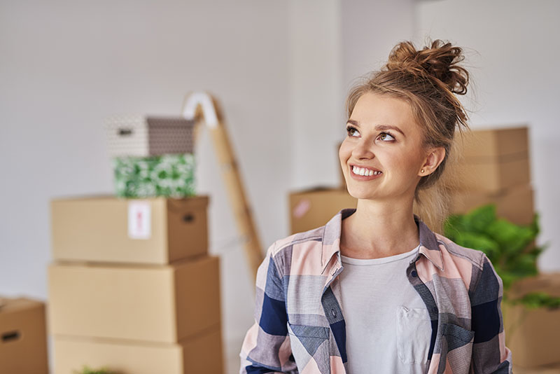 How to keep your rental tenants happy - woman smiling at home