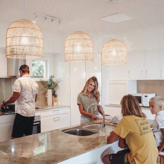 Family sitting around the kitchen in rental home