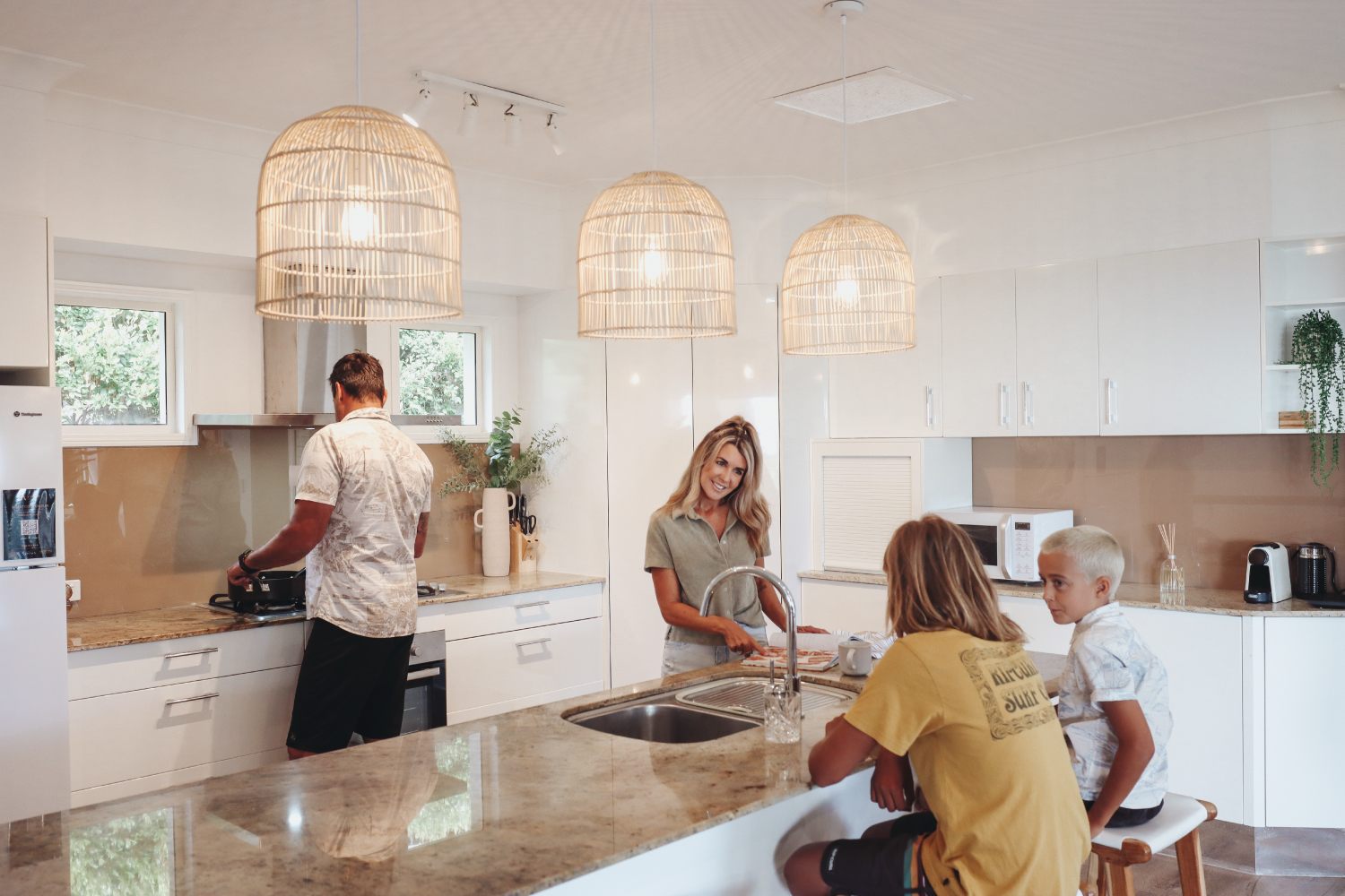 Family sitting around the kitchen in rental home