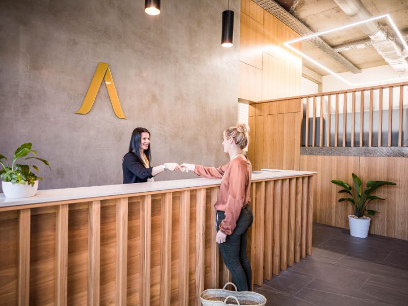 handing over keys to guest at aspire property management