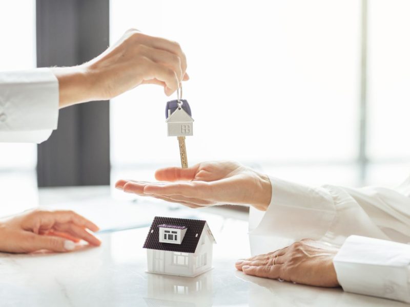 person handing keys to another person